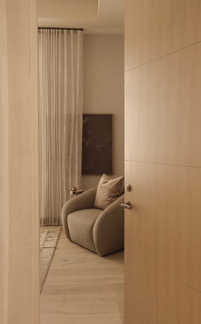 Sitting nook with curved chair and sheer drapery